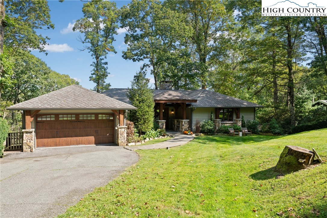 299 Edgewood Path Blowing Rock, NC 28605 - Photo 36 of 39 a front view of a house with a yard garage and outdoor seating