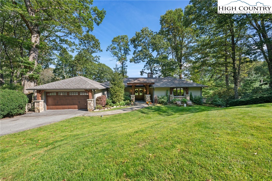 299 Edgewood Path Blowing Rock, NC 28605 - Photo 37 of 39 a view of a house with a yard and sitting area