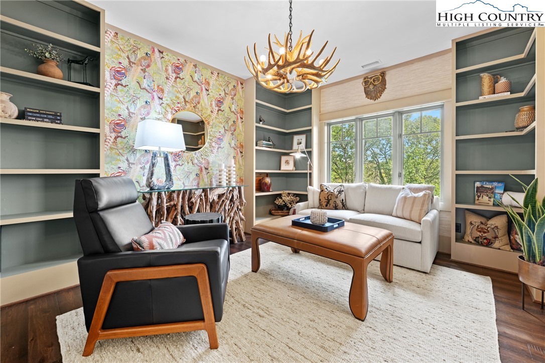 299 Edgewood Path Blowing Rock, NC 28605 - Photo 5 of 39 a living room with furniture a rug and a bookshelf