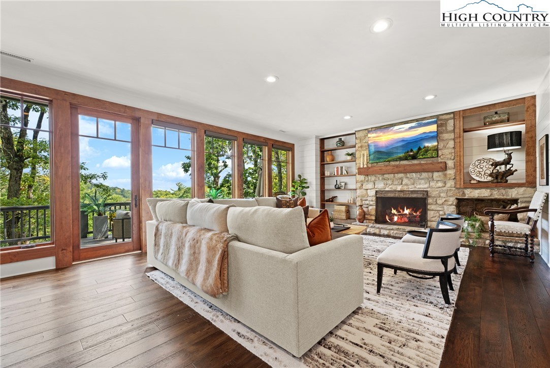 299 Edgewood Path Blowing Rock, NC 28605 - Photo 6 of 39 a living room with furniture a large window and a fireplace