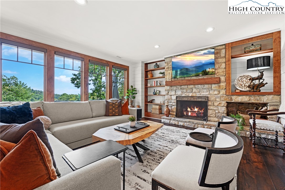 299 Edgewood Path Blowing Rock, NC 28605 - Photo 8 of 39 a living room with furniture a flat screen tv and a fireplace