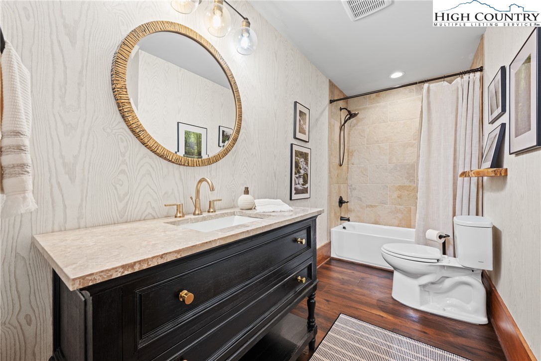 299 Edgewood Path Blowing Rock, NC 28605 - Photo 10 of 39 a bathroom with a granite countertop sink vanity mirror shower and a bathtub