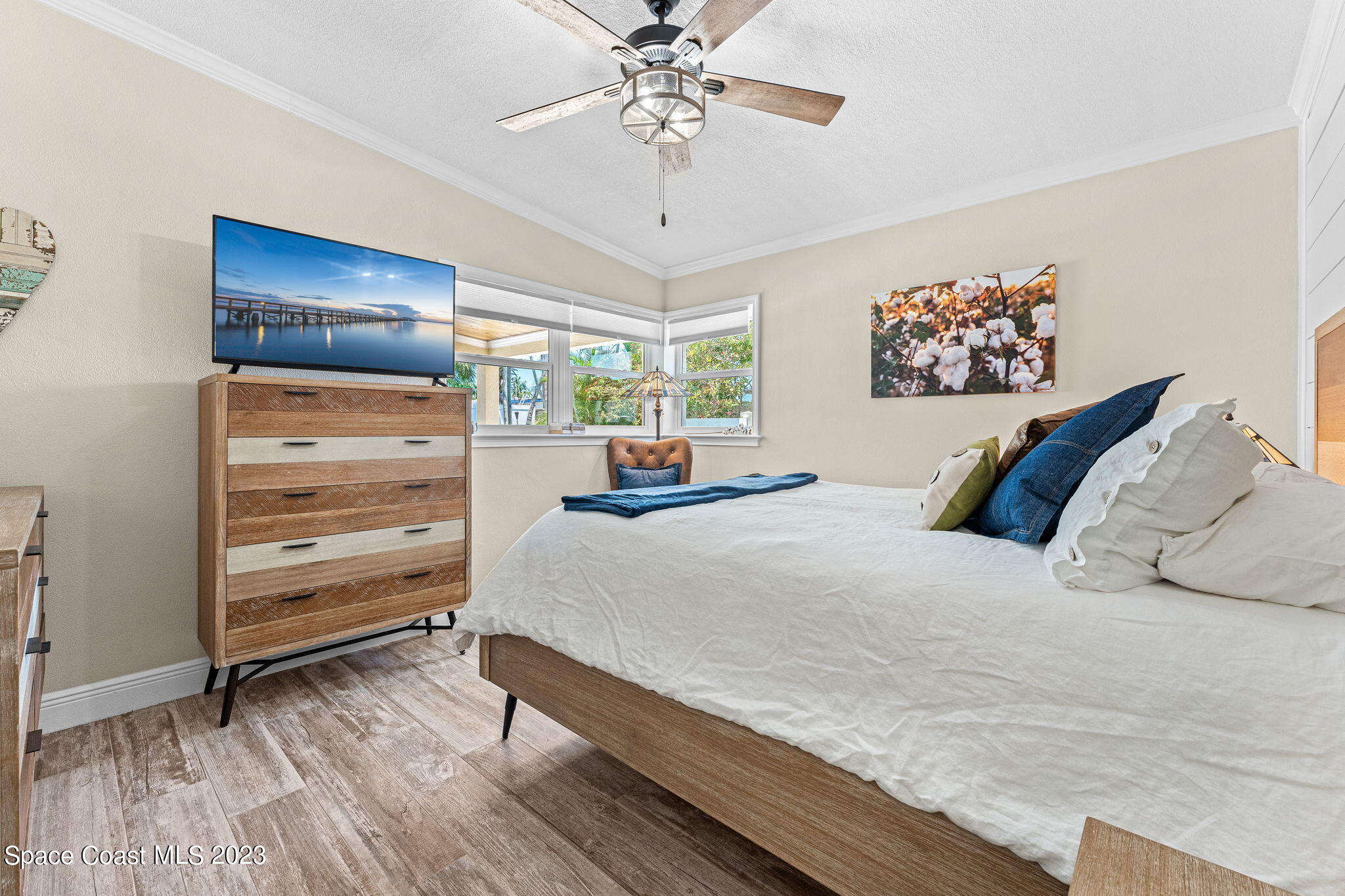 2230 Reef Avenue Indialantic, FL 32903 - Photo 11 of 31 a bedroom with a bed and a chandelier