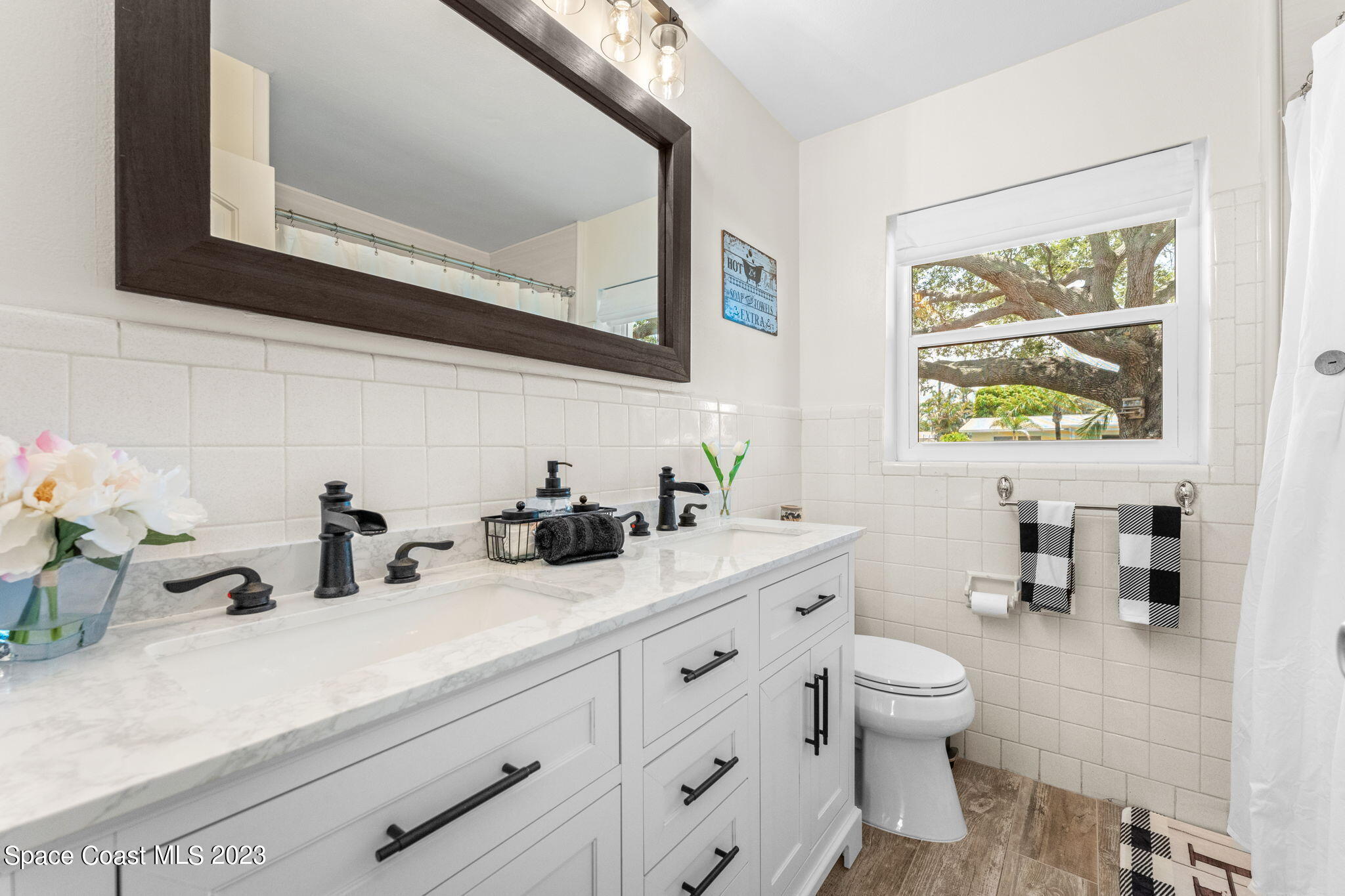 2230 Reef Avenue Indialantic, FL 32903 - Photo 12 of 31 a bathroom with a toilet sink and mirror