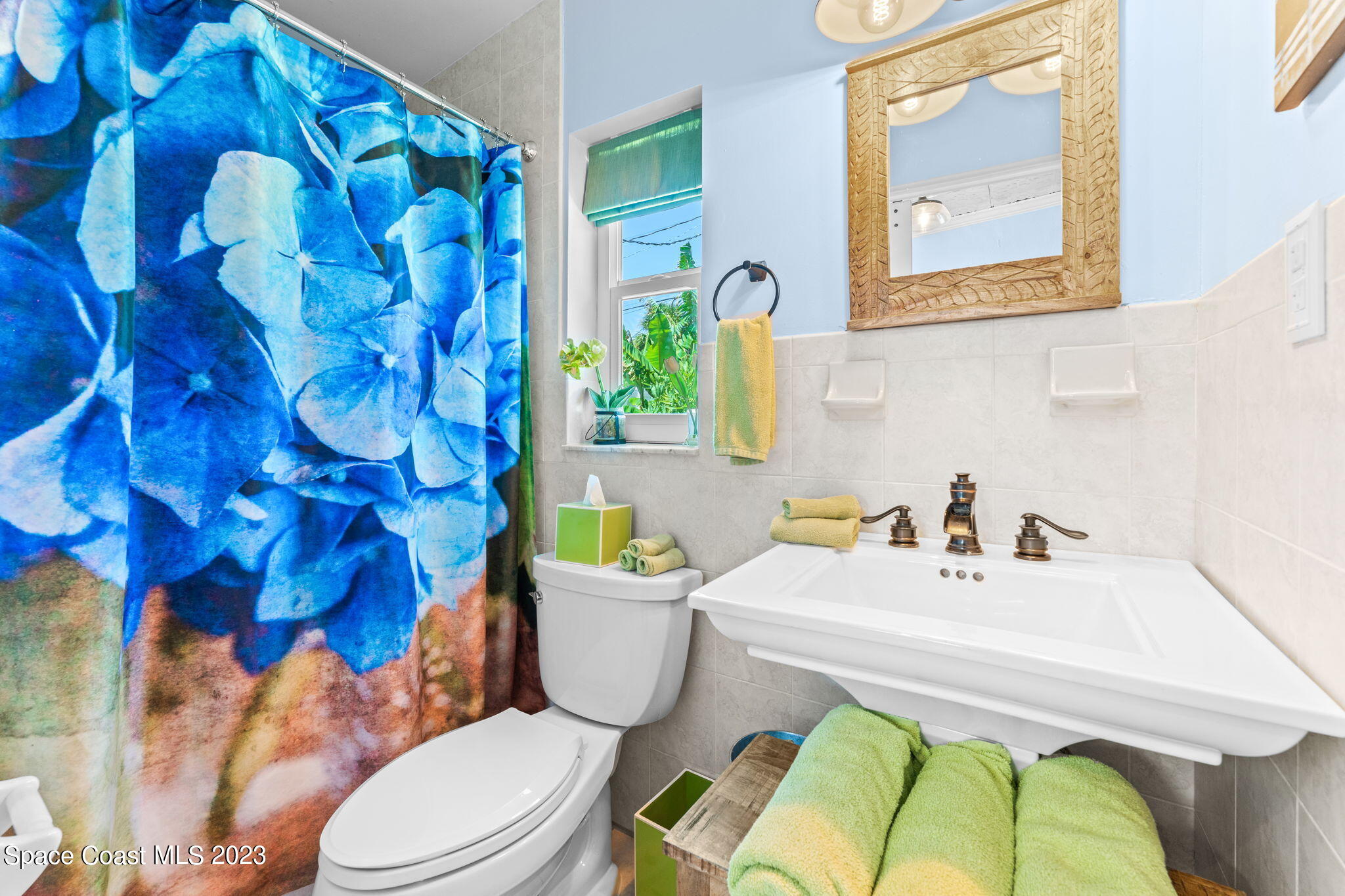 2230 Reef Avenue Indialantic, FL 32903 - Photo 15 of 31 a bathroom with a sink a toilet and a mirror
