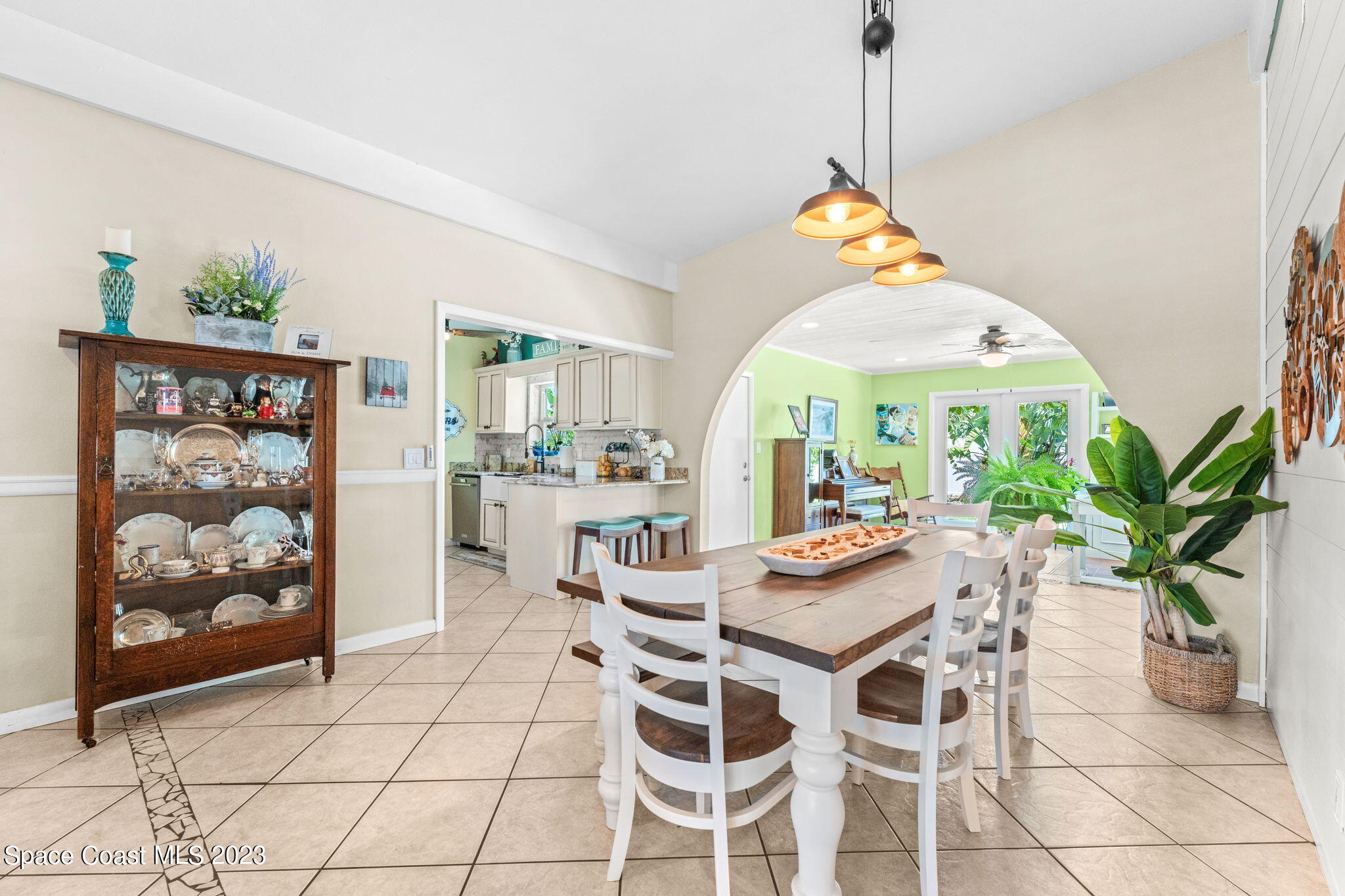 2230 Reef Avenue Indialantic, FL 32903 - Photo 6 of 31 a dining room filled a chandelier and kitchen view