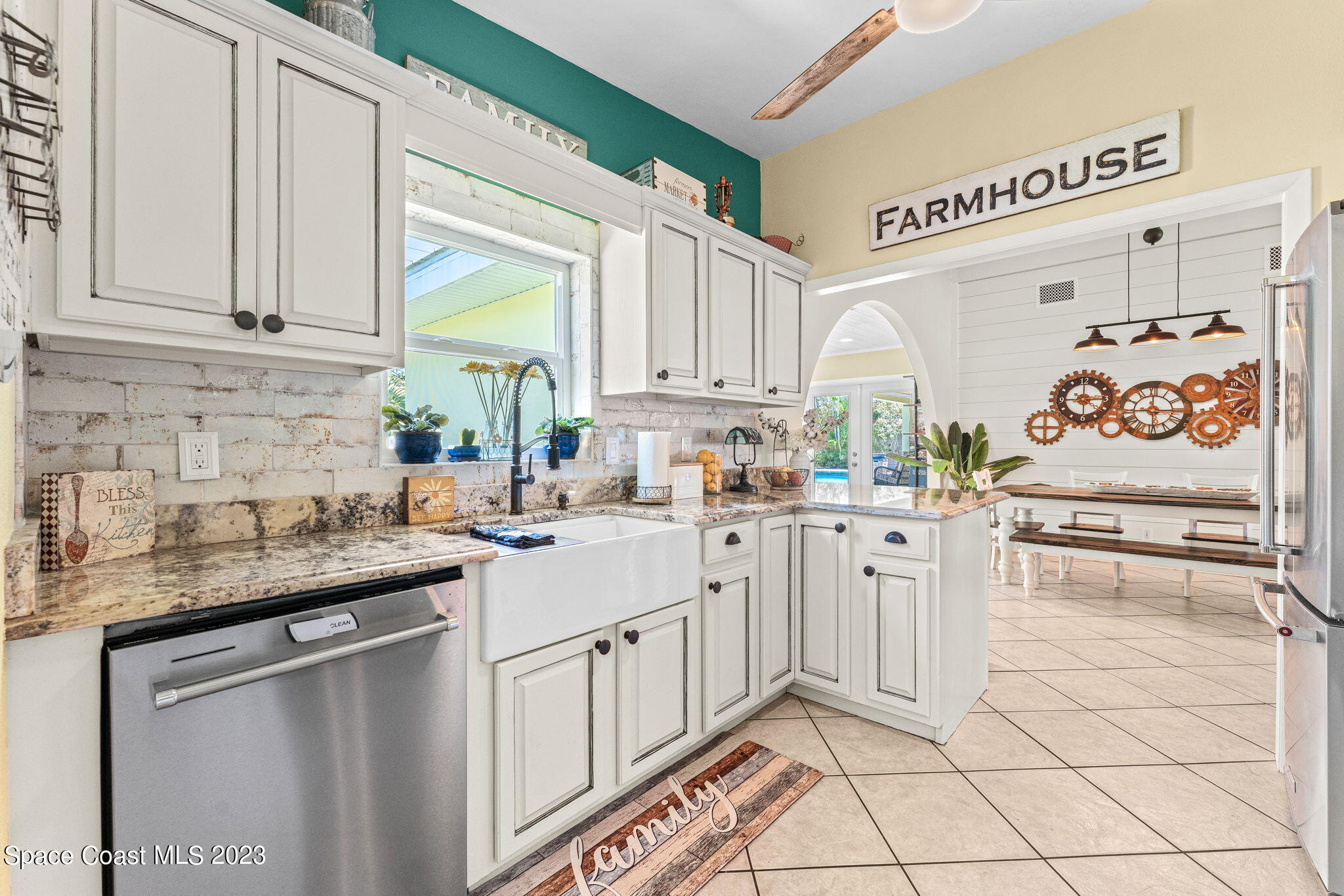 2230 Reef Avenue Indialantic, FL 32903 - Photo 8 of 31 a kitchen with white cabinets and white appliances