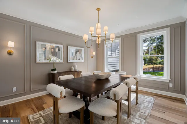 a living room with furniture kitchen view and a large window