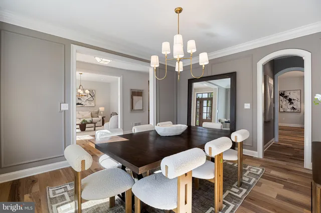 a living room with furniture a large window and a fireplace