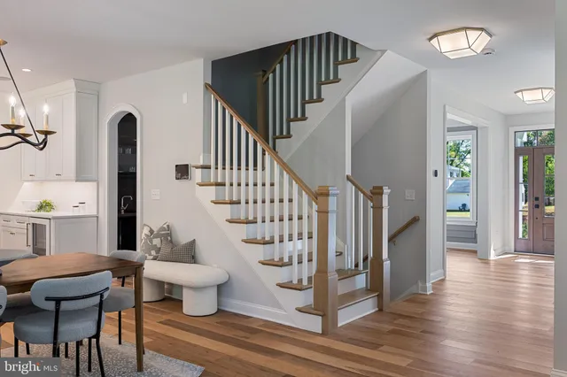 a dining room with furniture a chandelier and wooden floor