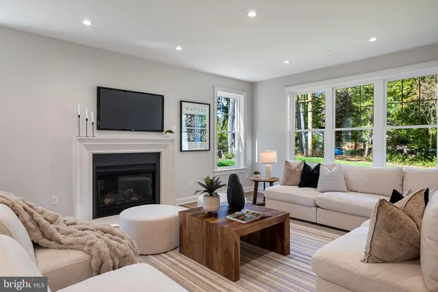 a kitchen with a sink dishwasher a stove and white cabinets