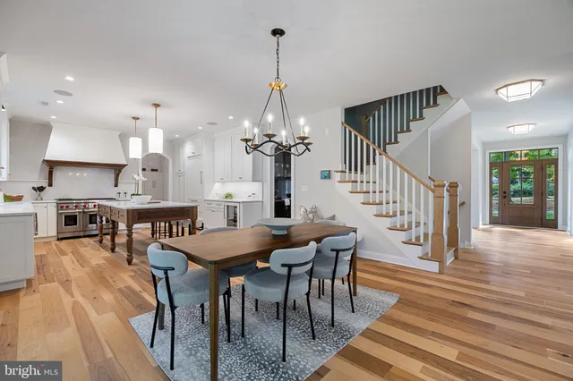 a living room with furniture a large window and a chandelier