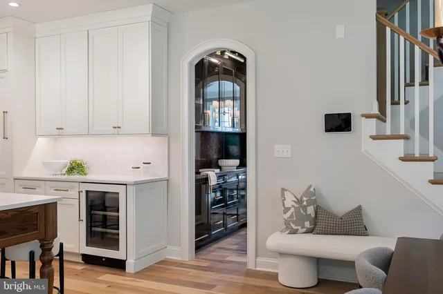 a spacious bathroom with a double vanity sink a mirror a bathtub and a window