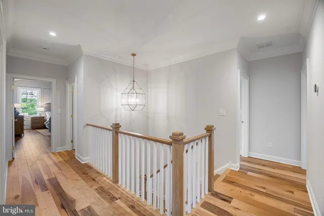 a view of a room with wooden floor and a bathroom