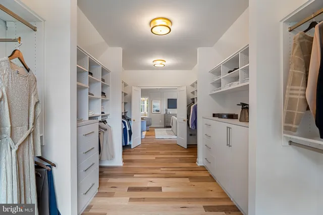 a bathroom with a toilet sink vanity and mirror