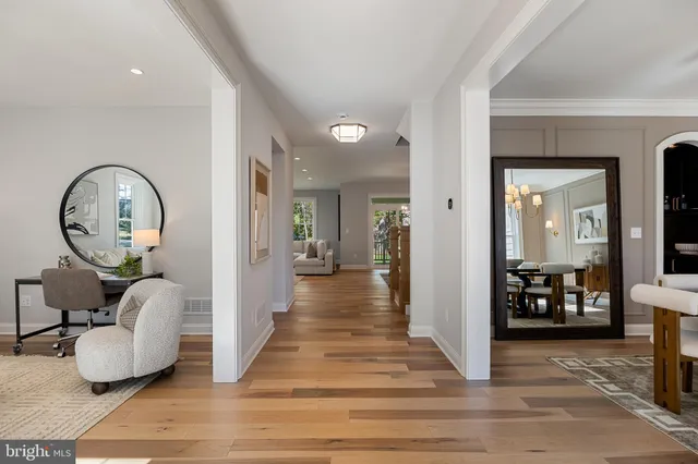 a living room with furniture a chandelier and a window