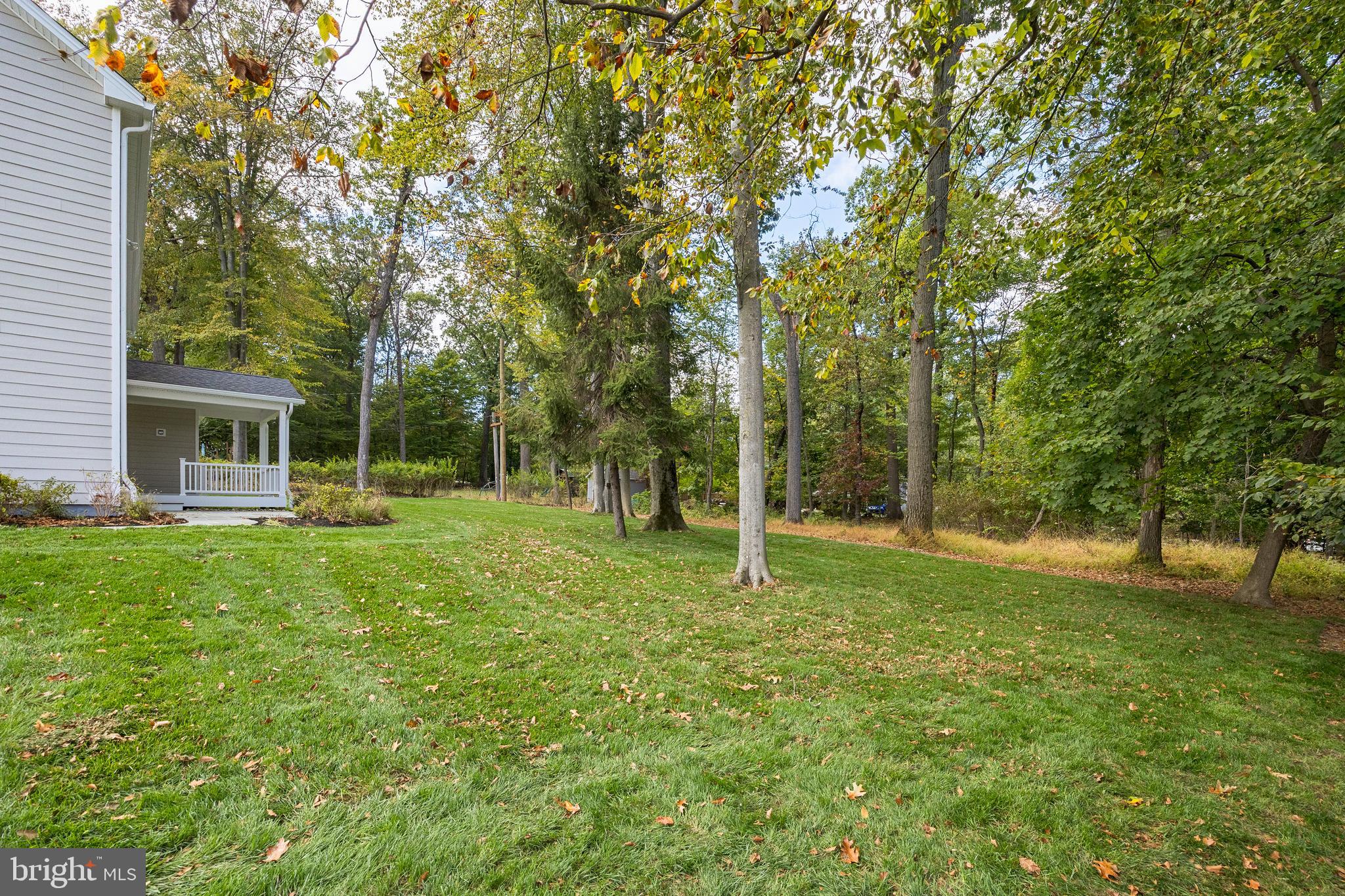 211 Wooded Way Berwyn, PA 19312 - Photo 10 of 11 a backyard of a house with swimming pool and large trees