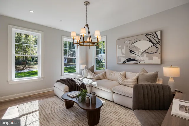 a view of a dining room with furniture a chandelier and wooden floor