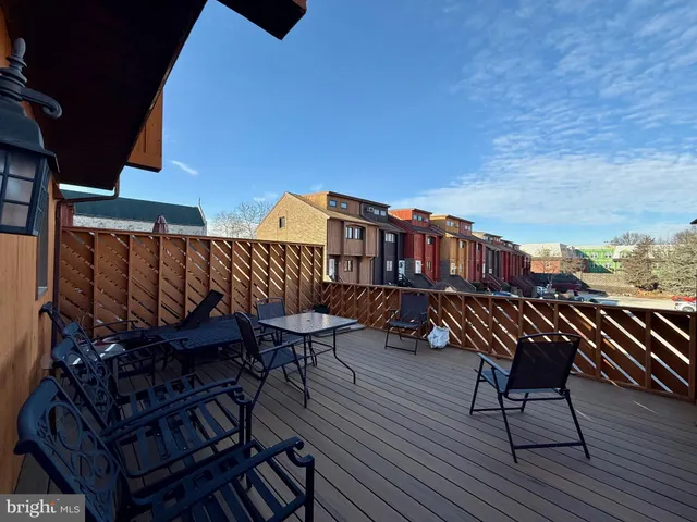 a roof deck view with table and chairs