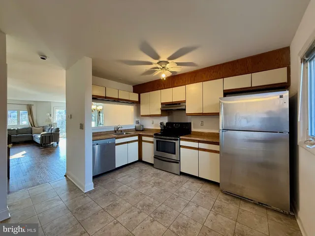 a kitchen with a refrigerator and a sink