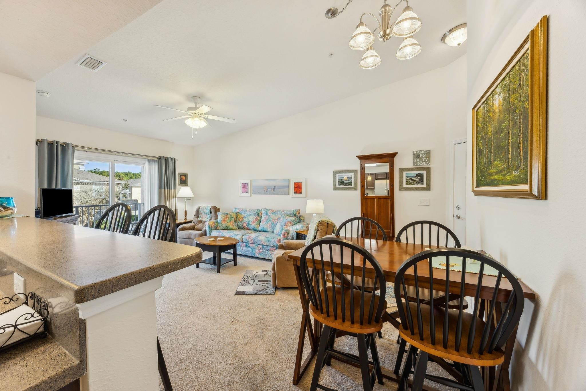 2861 Golden Lake Loop St. Augustine, FL 32084 - Photo 12 of 40 Dining room with vaulted ceiling, a chandelier, a ceiling fan, and light carpet