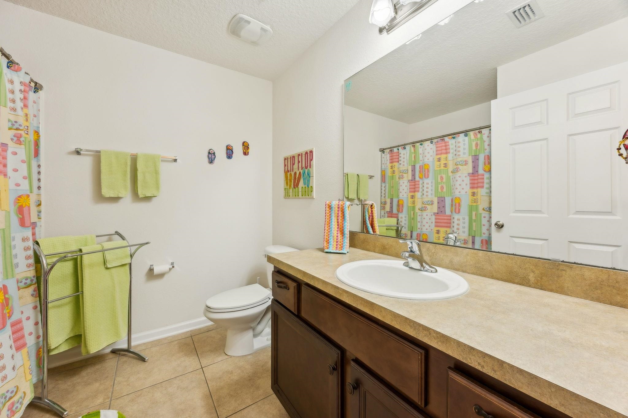 2861 Golden Lake Loop St. Augustine, FL 32084 - Photo 23 of 40 Full bath featuring vanity, a shower with curtain, light tile patterned floors, and a textured ceiling