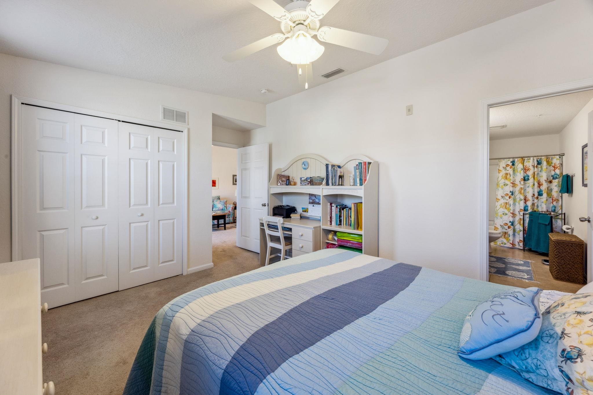 2861 Golden Lake Loop St. Augustine, FL 32084 - Photo 28 of 40 Bedroom featuring carpet, ceiling fan, a closet, and ensuite bath