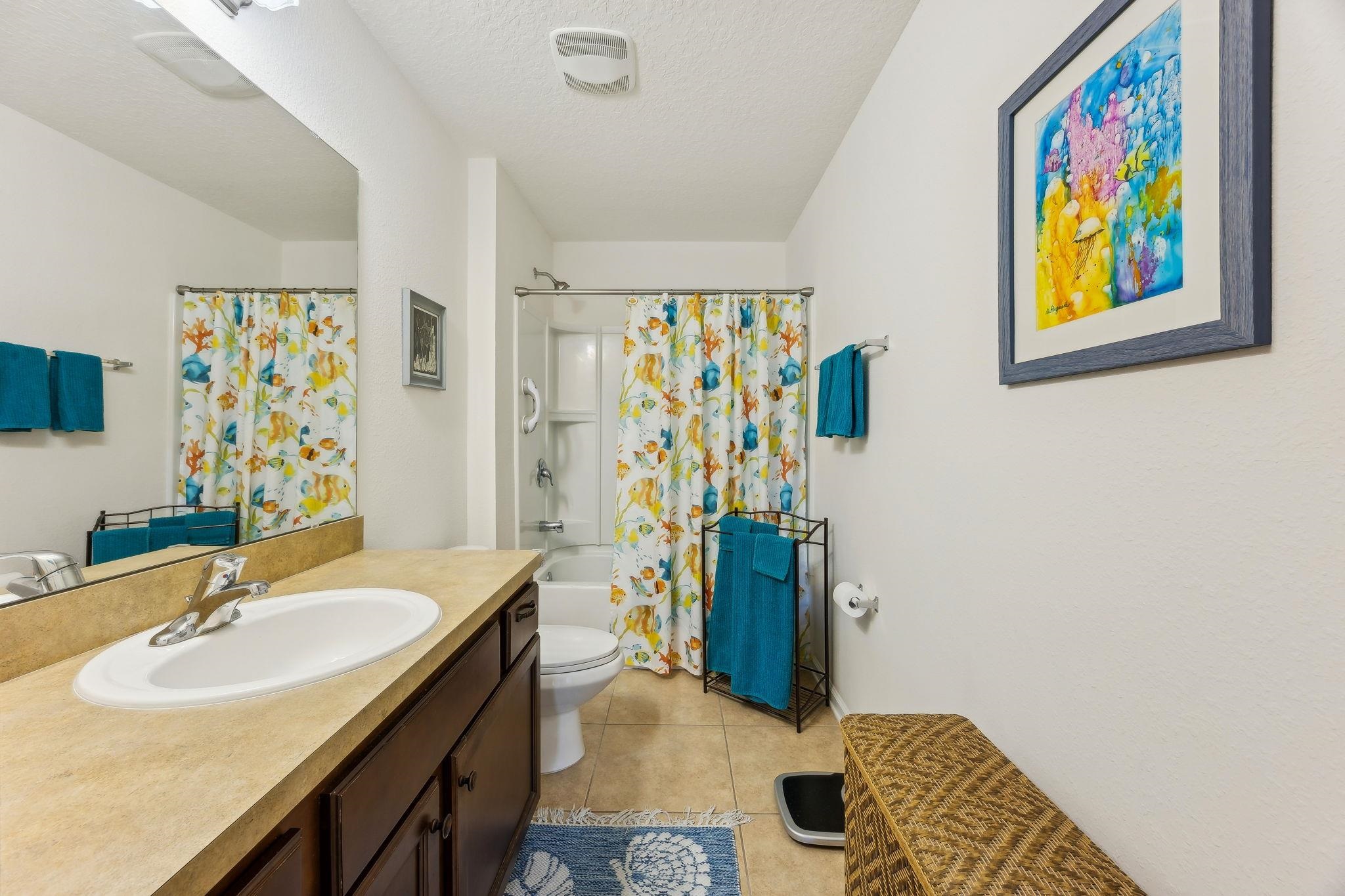 2861 Golden Lake Loop St. Augustine, FL 32084 - Photo 30 of 40 Bathroom featuring shower / bath combo with shower curtain, vanity, light tile patterned floors, and a textured ceiling