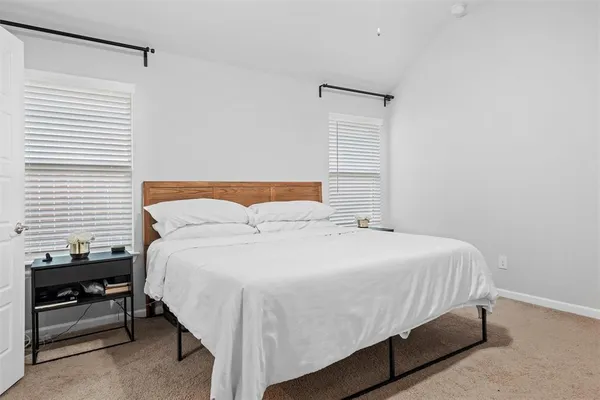 a bedroom with a bed and a night stand