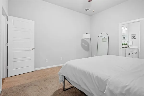 a bedroom with a bed and a dresser
