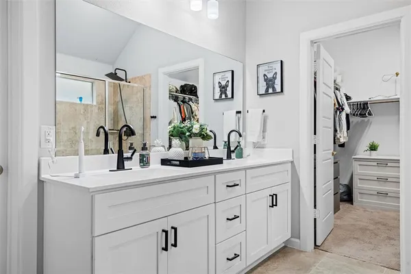 a bathroom with cabinets sink and a mirror