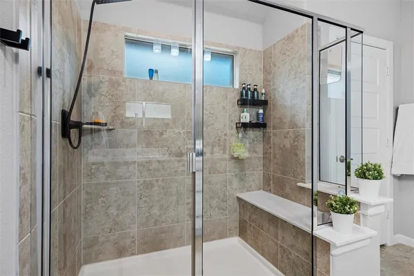 a bathroom with a shower and a mirror