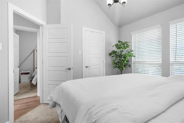 a bedroom with a bed and a potted plant