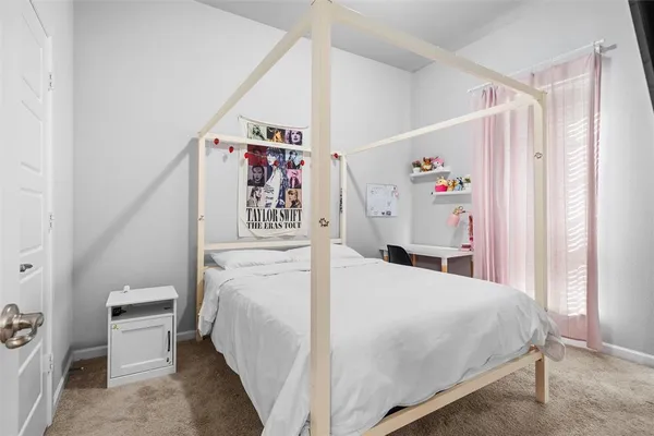 a bedroom with a bed and a white cabinet