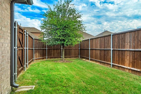a backyard with wooden fence
