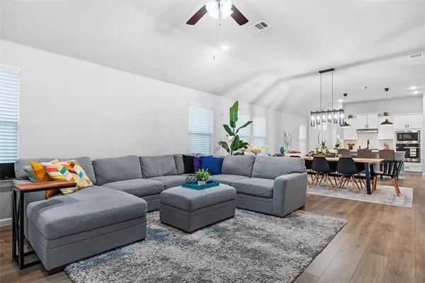 a living room with furniture and wooden floor
