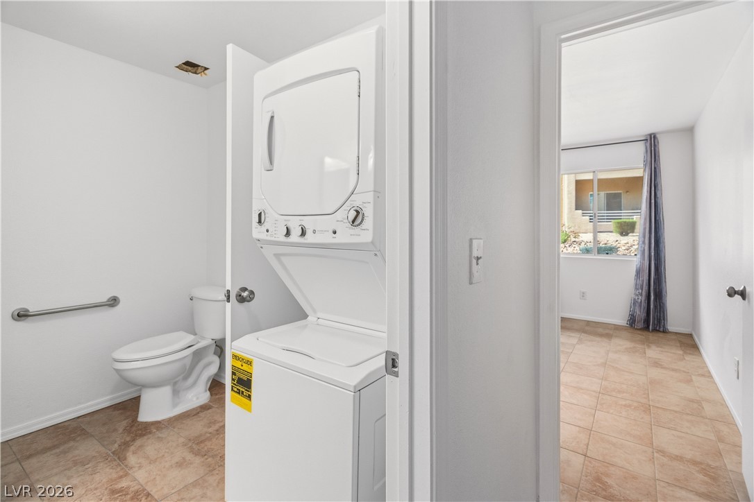 2232 Aspen Mirror Way, Unit 103 Laughlin, NV 89029 - Photo 13 of 50 Laundry area featuring stacked washer / drying machine and light tile patterned flooring