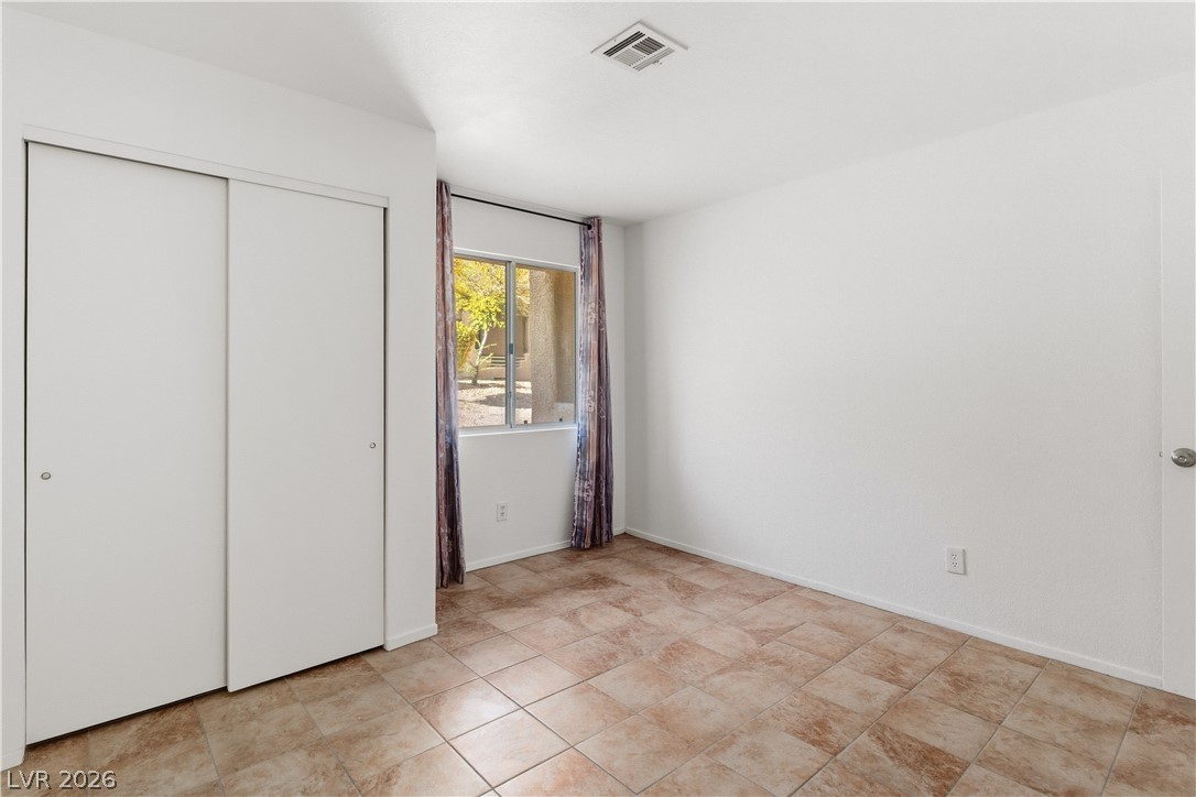 2232 Aspen Mirror Way, Unit 103 Laughlin, NV 89029 - Photo 18 of 50 Unfurnished bedroom featuring a closet