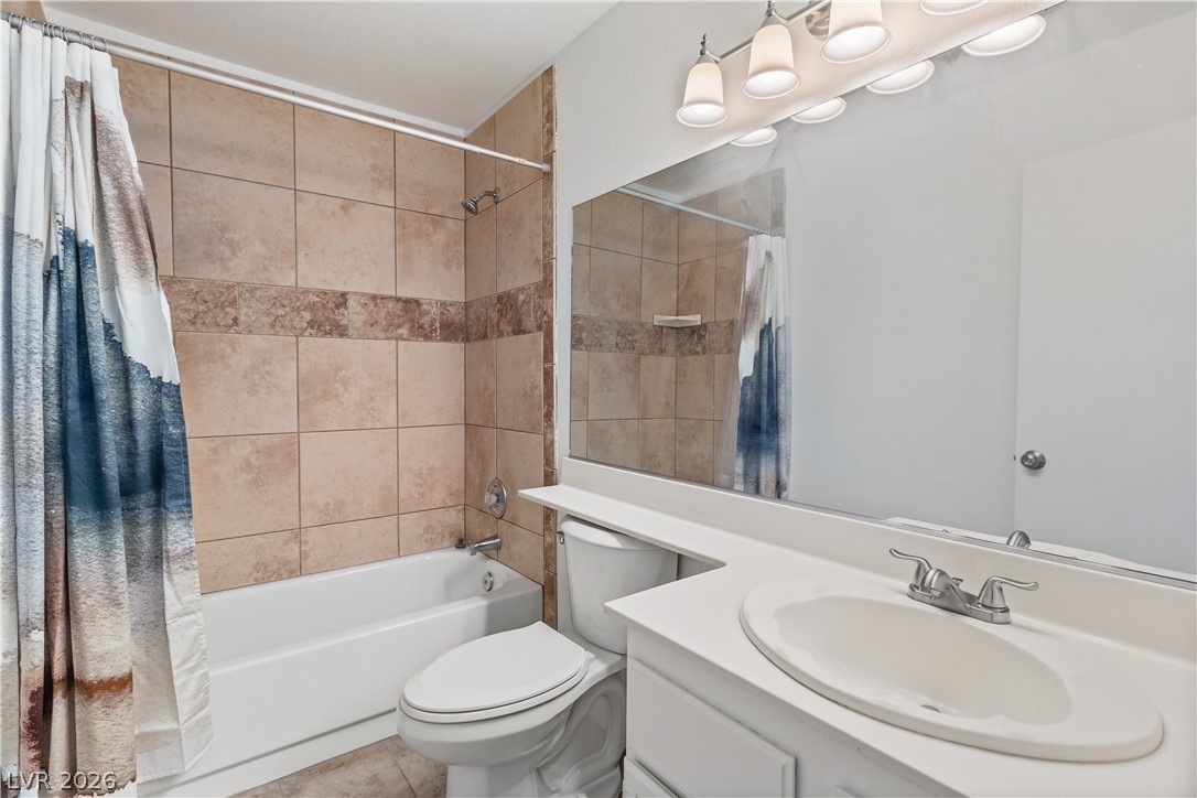 2232 Aspen Mirror Way, Unit 103 Laughlin, NV 89029 - Photo 19 of 50 Bathroom with shower / bathtub combination with curtain and vanity