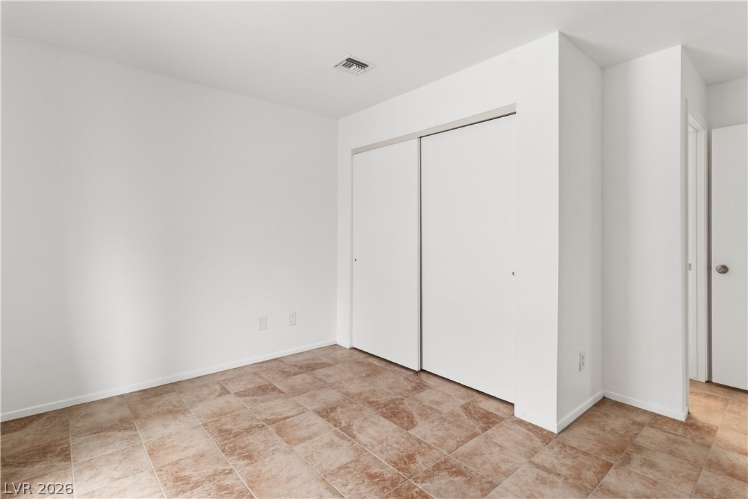 2232 Aspen Mirror Way, Unit 103 Laughlin, NV 89029 - Photo 21 of 50 Unfurnished bedroom featuring a closet and baseboards