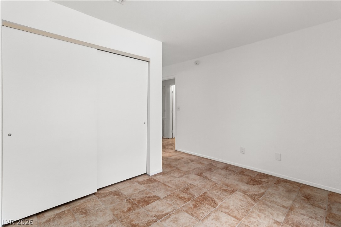 2232 Aspen Mirror Way, Unit 103 Laughlin, NV 89029 - Photo 22 of 50 Unfurnished bedroom featuring a closet and baseboards