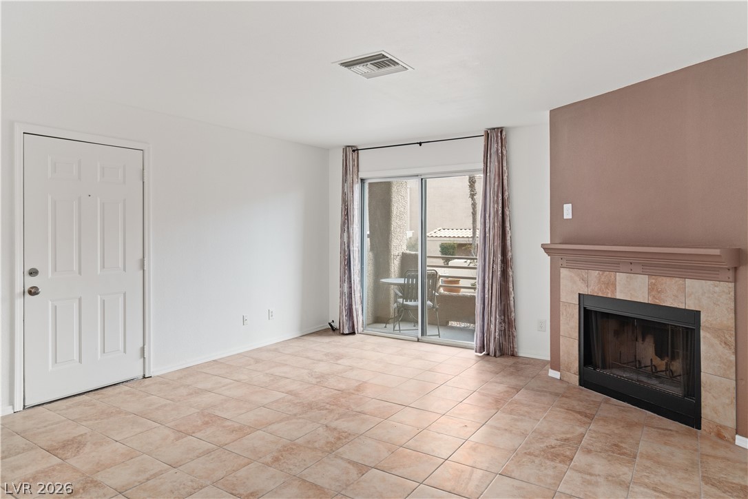 2232 Aspen Mirror Way, Unit 103 Laughlin, NV 89029 - Photo 3 of 50 Unfurnished living room featuring a fireplace and baseboards