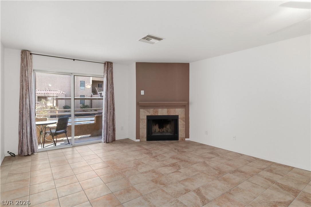 2232 Aspen Mirror Way, Unit 103 Laughlin, NV 89029 - Photo 5 of 50 Living area featuring a tiled fireplace