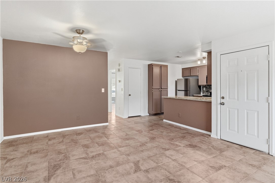 2232 Aspen Mirror Way, Unit 103 Laughlin, NV 89029 - Photo 7 of 50 Unfurnished living room featuring ceiling fan and baseboards