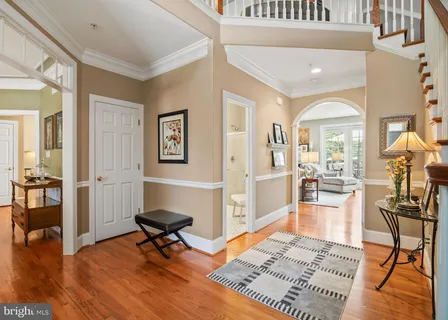 a kitchen with stainless steel appliances granite countertop a stove top oven a sink dishwasher and a refrigerator with wooden floor