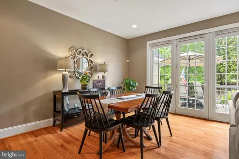 a bedroom with a bed large window and furniture