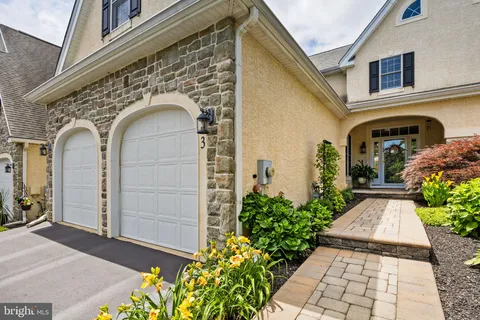 a living room with fireplace furniture and a large window