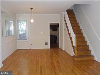 1205 Beech Street Wilmington, DE 19805 - Photo 3 of 13 a view of an empty room with wooden floor and windows