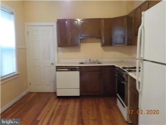 1205 Beech Street Wilmington, DE 19805 - Photo 5 of 13 a kitchen with a sink and a stove top oven