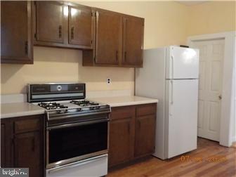 1205 Beech Street Wilmington, DE 19805 - Photo 6 of 13 a kitchen with a stove and a refrigerator